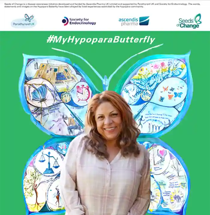Image shows a mural in the shape of a butterfly. The wings are covered in quotes and drawings. A smiling woman is standing in front of the Hypopara Butterfly.